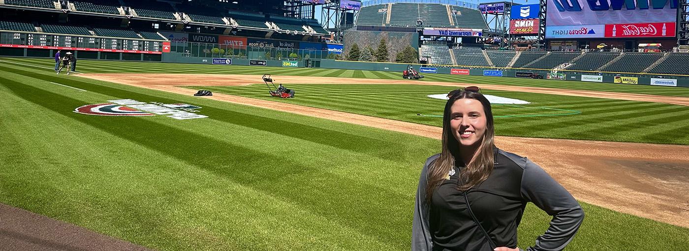 Photo of woman on a baseball field.